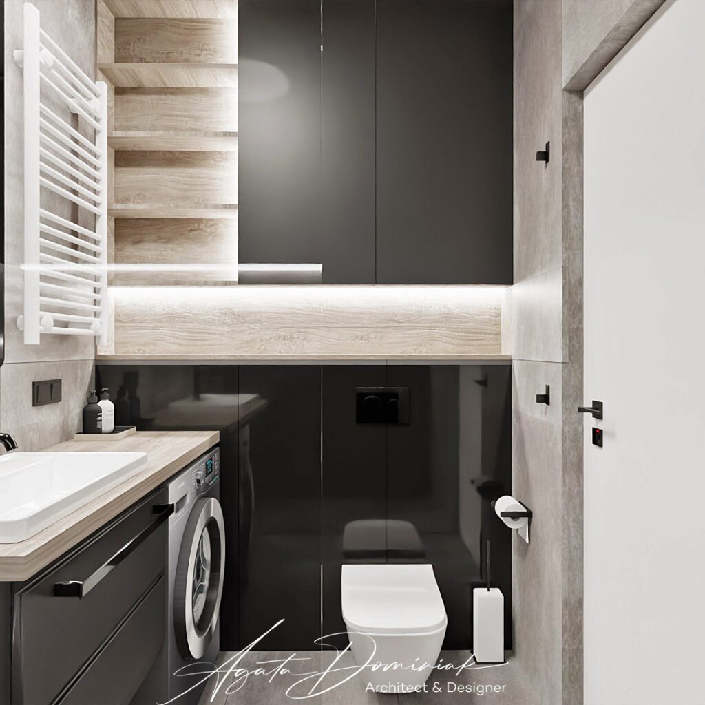 Łazienka z czarnymi płytkami i pralką pod blatem